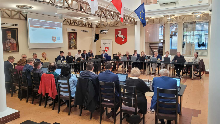 Sesja Rady Miasta Konina. Na zdjęciu widać radnych oraz prezydentów przy stole w sali obrad w ratuszu.
